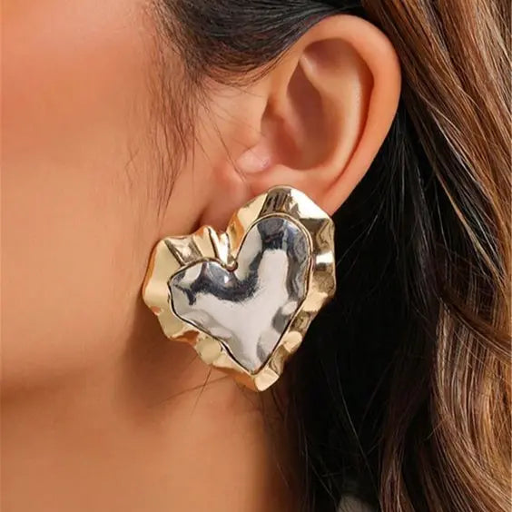 Hjerte øreringe lavet af guld og sølv