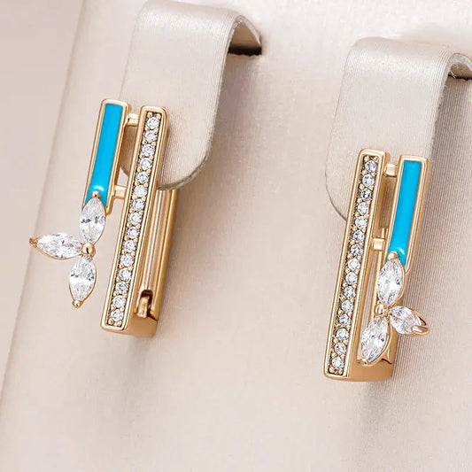 Elegante øreringe med blå emalje og zirkonia i guld