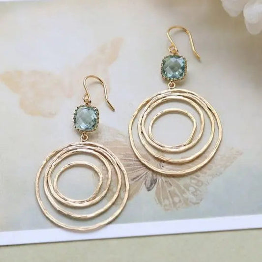 Vintage øreringe med spiralmønster i guld og zirkonium